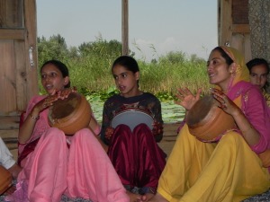 Mulheres cantando com a noiva durante os preparativos.